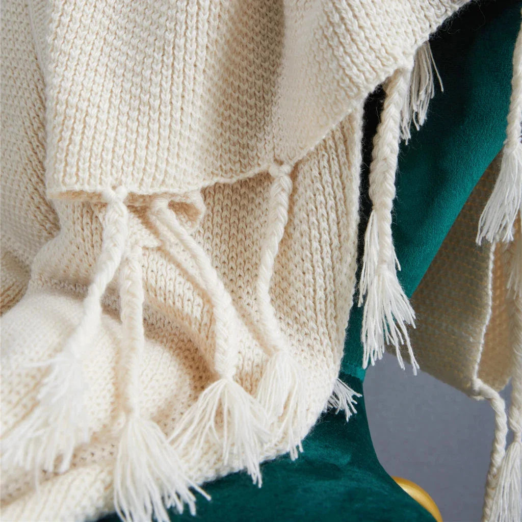 Luxurious Nordic wool knitted throw blanket with tassels in a solid gray color, a cozy and elegant home decor accessory