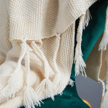 Luxurious Nordic wool knitted throw blanket with tassels in a solid gray color, a cozy and elegant home decor accessory