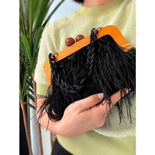 Elegant green feather evening clutch with chic acrylic chain, a stylish and practical accessory for formal and casual events
