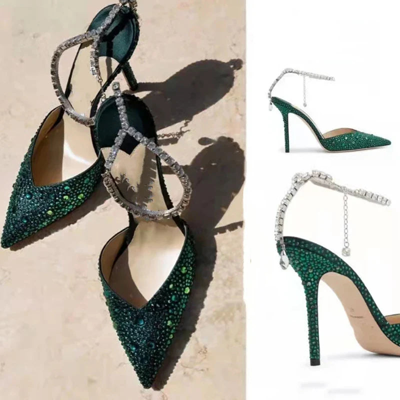 Glamorous rhinestone-embellished stiletto sandals in black and green colors, featuring a pointed toe and sleek silhouette