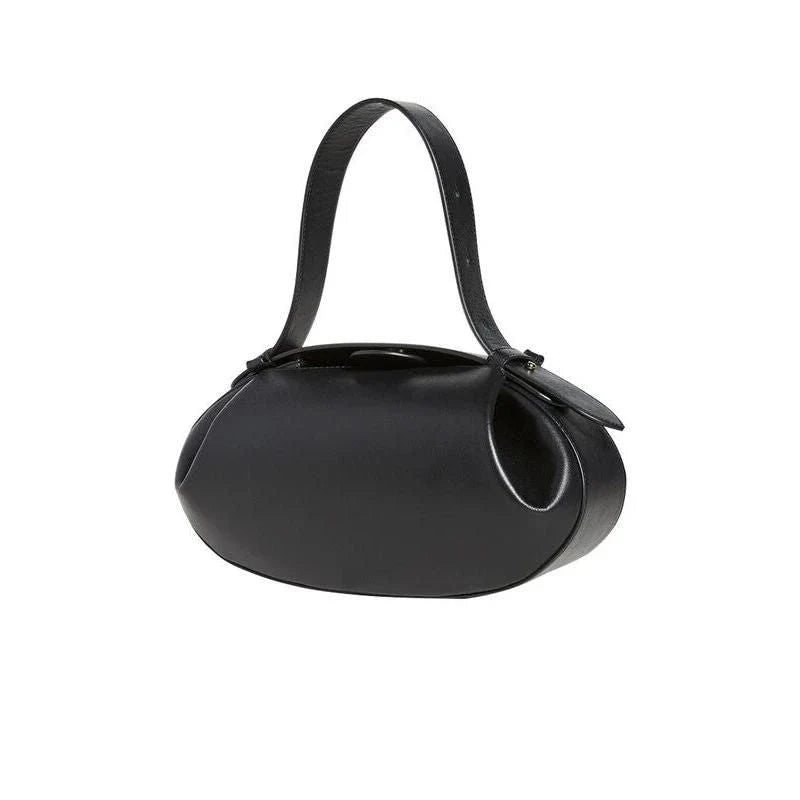 Circular vegan leather handbag in a tan color, with a sturdy build and thoughtful interior design for versatile use.