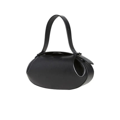 Circular vegan leather handbag in a tan color, with a sturdy build and thoughtful interior design for versatile use.
