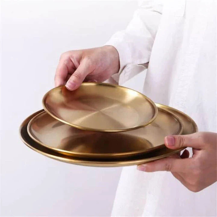 Elegant European-style round dinner plates made of premium stainless steel with a luxurious gold finish
