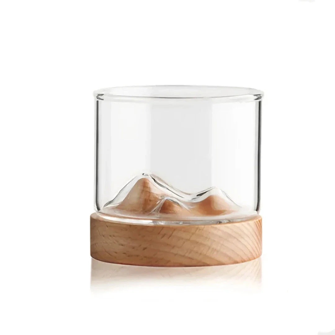 Elegant mountain-inspired whiskey glass with a wooden base, perfect for enjoying a variety of hot and cold beverages