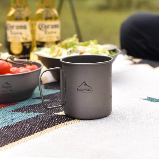 Titanium camping mug with lid, foldable design, available in multiple sizes for outdoor adventures