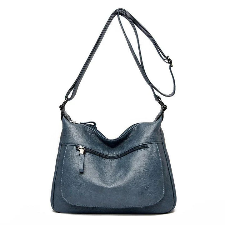 Stylish one-shoulder messenger bag in various colors with a soft, supple PU leather exterior and a spacious, organized main compartment