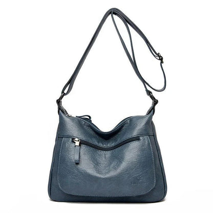 Stylish one-shoulder messenger bag in various colors with a soft, supple PU leather exterior and a spacious, organized main compartment