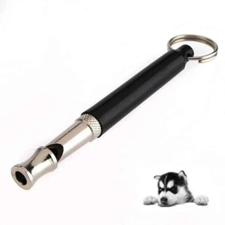 Compact dog training whistle made of metal and plastic with a black and silver design