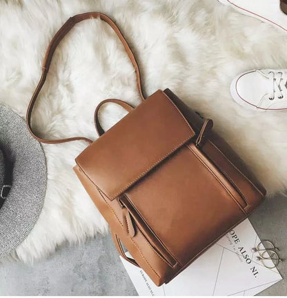 Versatile British-inspired shoulder bag made from high-quality PU leather with a spacious main compartment, convenient pockets, and an adjustable strap