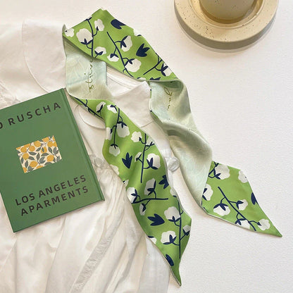 Elegant floral silk skinny scarf with versatile styling options for modern fashion-forward women