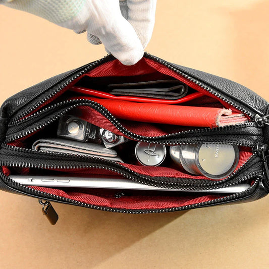 Cowhide shoulder bag in various colors, featuring a sleek and modern design with multiple internal pockets for organization.