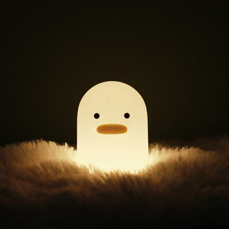 Cute duck-shaped LED night light with silicone and ABS construction, USB charging, and adjustable brightness