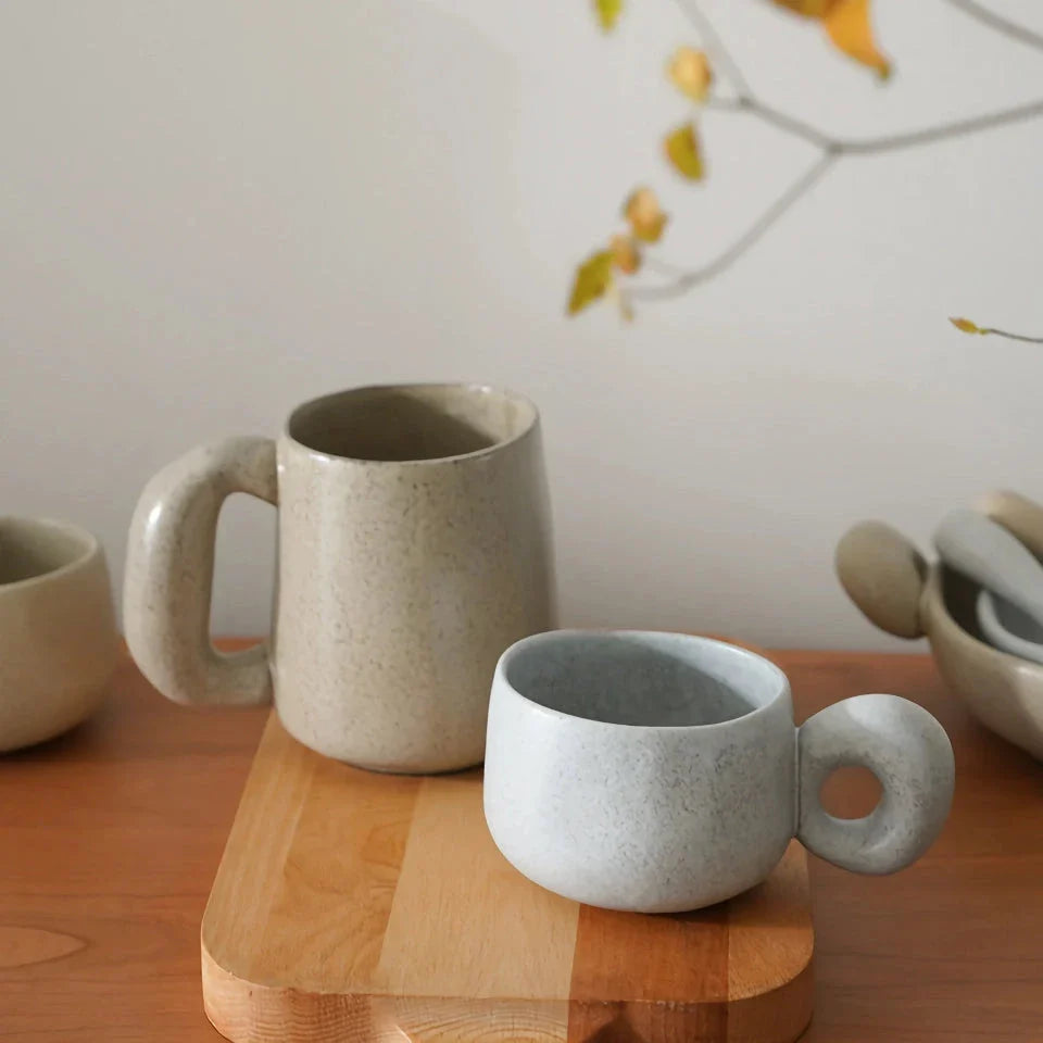 Handcrafted Japanese stoneware retro coffee mug in apricot and grey colors with a comfortable grip and minimalist design