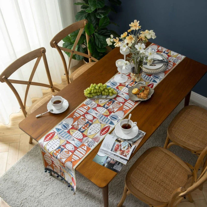 Festive jacquard table runner with vibrant fish design, available in multiple sizes to fit various dining tables