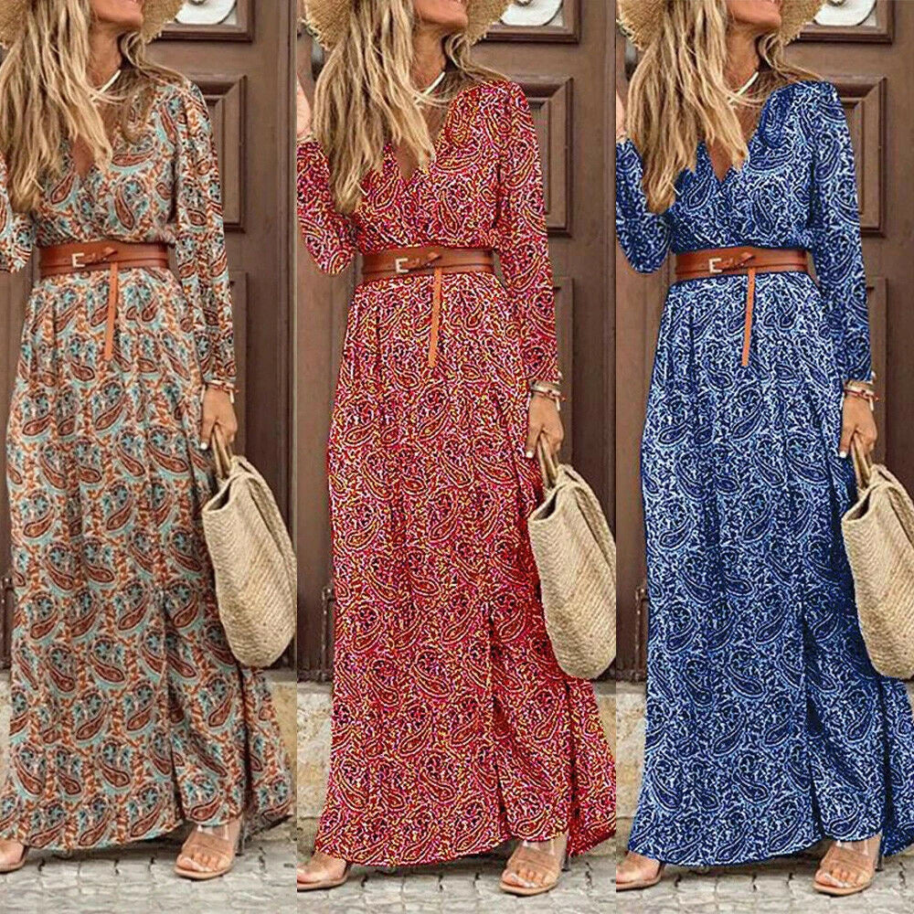 A long sleeve v-neck bohemian-style floral dress with a flowing, long skirt in a dark blue color.
