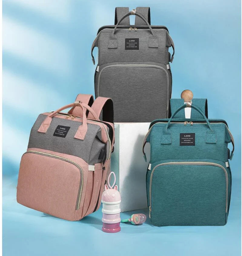 Multifunctional maternity diaper backpack with detachable crib, large capacity, and water-resistant design for travel