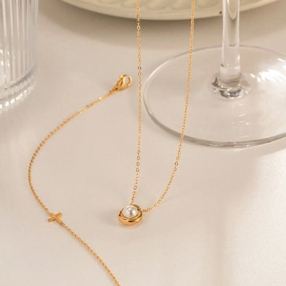 Elegant stainless steel pearl pendant necklace with a geometric design, perfect for women's fashion and everyday style.