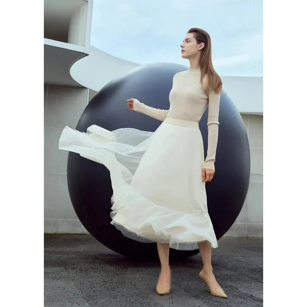 Elegant gauze A-line skirt in beige and white colors, featuring a graceful ankle-length design and unique patchwork detailing for a sophisticated look.