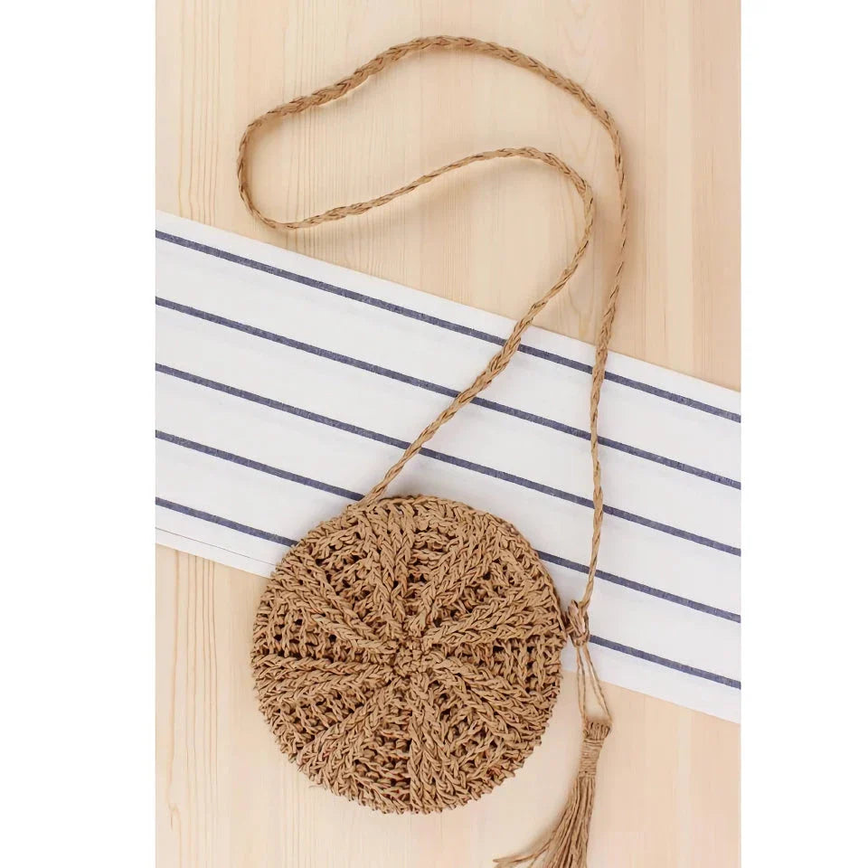 Bohemian rattan round crossbody bag in beige color with tassel accent, perfect for summer outings and beach parties