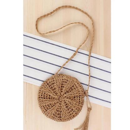 Bohemian rattan round crossbody bag in beige color with tassel accent, perfect for summer outings and beach parties