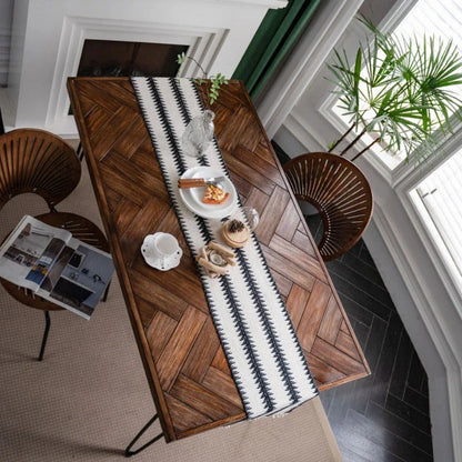Elegant black and white cotton table runner with striped pattern and tassels, perfect for sophisticated dining experiences