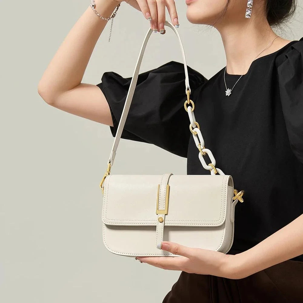 Elegant white leather crossbody bag for women with adjustable strap and multiple interior pockets for organized storage.