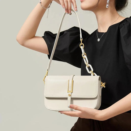 Elegant white leather crossbody bag for women with adjustable strap and multiple interior pockets for organized storage.