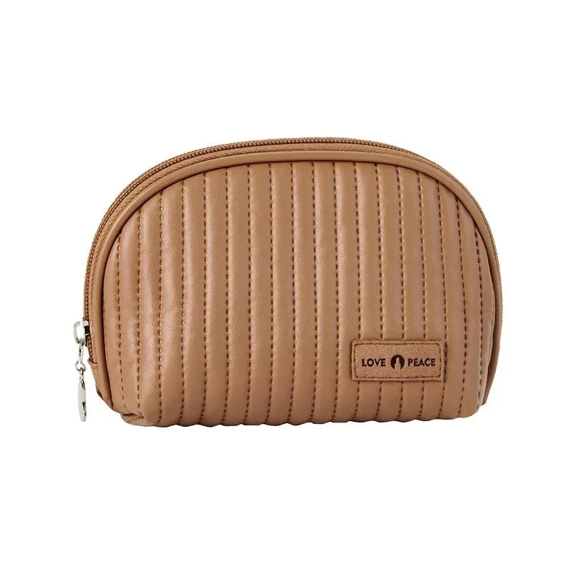Stylish compact makeup bag made of premium PU leather in light blue color, with a sleek minimalist design for modern women