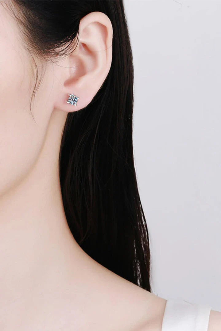 A pair of 1 carat moissanite stud earrings made of 925 sterling silver with a rhodium plating for a dazzling shine.