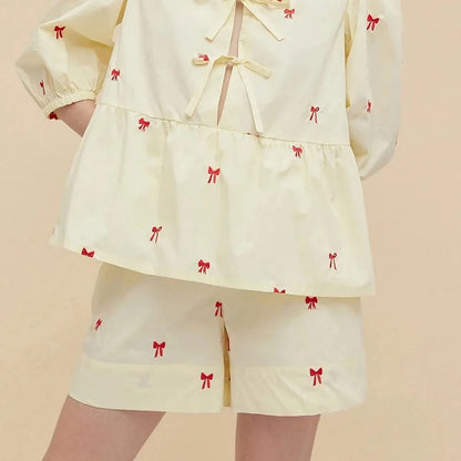 A stylish bow-embroidered shorts set featuring a delicate hollow-out short sleeve top and comfortable, stretchy fabric for effortless summer style.