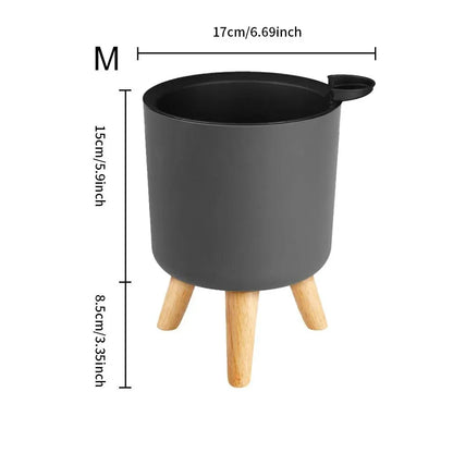 A modern self-watering planter with a wooden stand, designed to simplify indoor gardening and enhance any space with its chic and functional features.