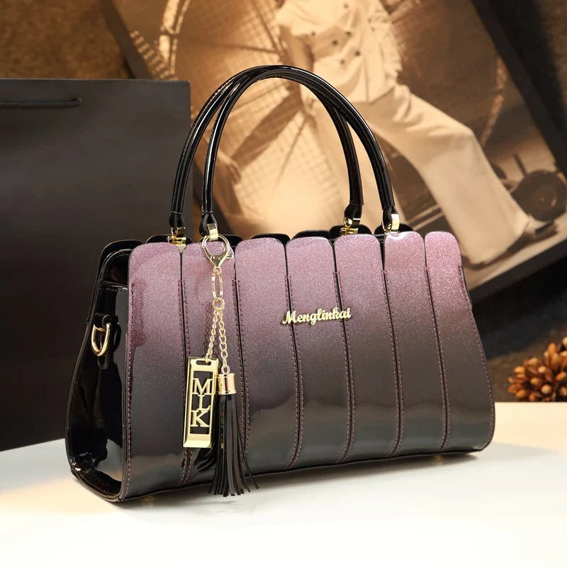 Premium patent leather crossbody handbag in fuchsia color with multiple pockets for organization and adjustable strap for hands-free convenience