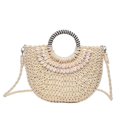 Handmade straw woven crossbody handbag with seashell accents, perfect for summer beach and resort wear