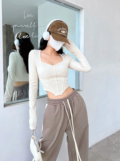 A stylish slim-fit short autumn top with an open waist design, made of premium polyester fabric with long sleeves and a square collar.