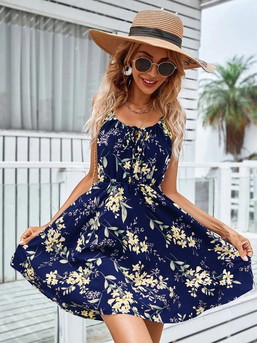 A stylish floral print suspender dress with an elastic waist, perfect for summer fashion and casual or dressy occasions.