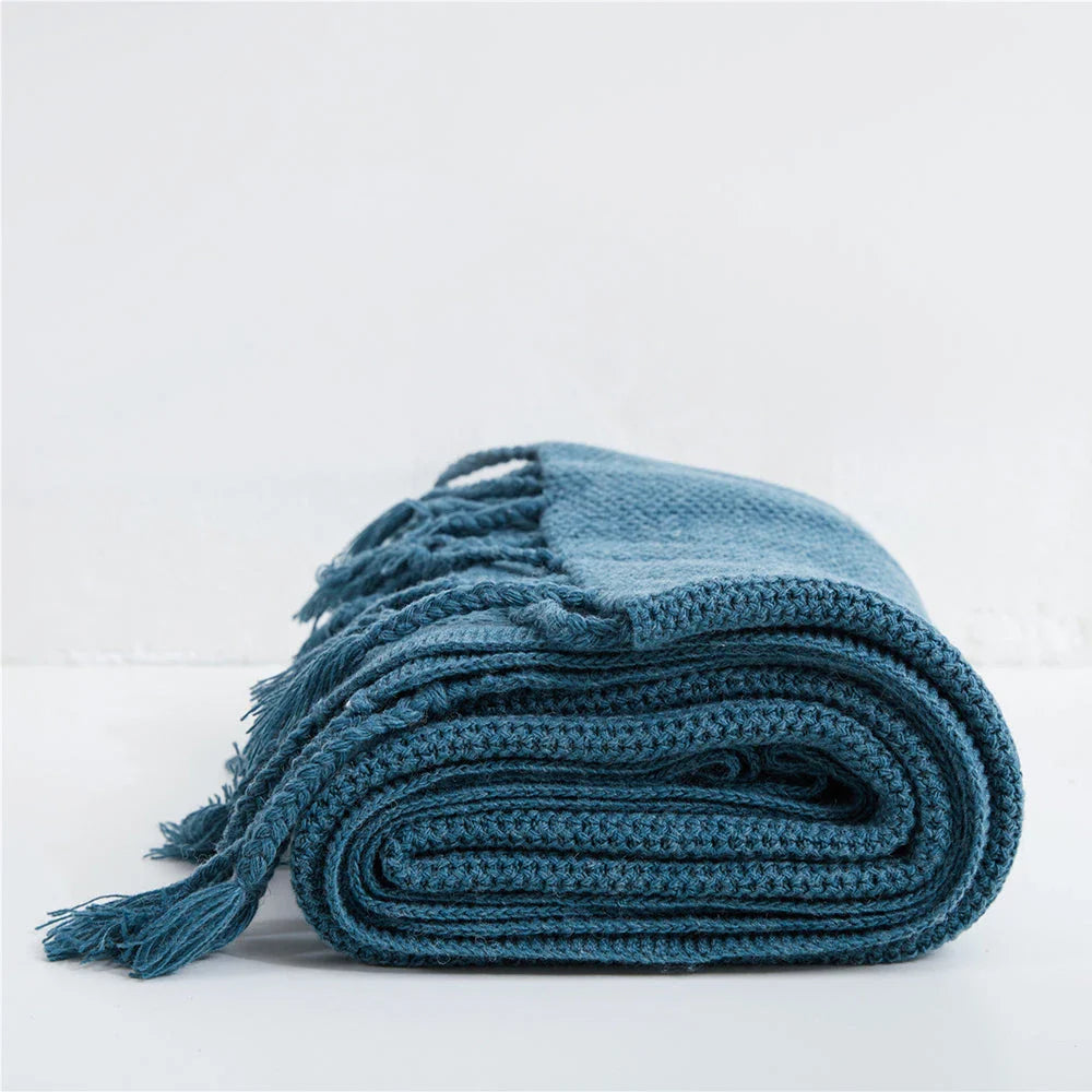 Luxurious Nordic wool knitted throw blanket with tassels in a solid gray color, a cozy and elegant home decor accessory