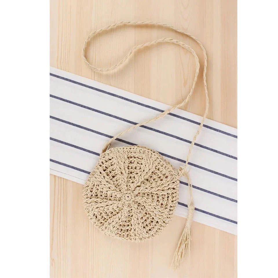 Bohemian rattan round crossbody bag in beige color with tassel accent, perfect for summer outings and beach parties