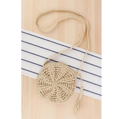 Bohemian rattan round crossbody bag in beige color with tassel accent, perfect for summer outings and beach parties