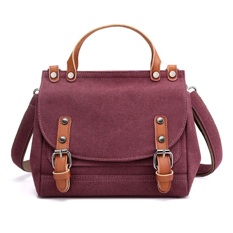 A stylish women's canvas crossbody handbag in an orange color, featuring a small square shape and a horizontal design.