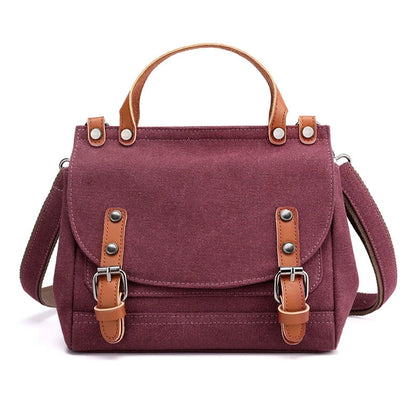A stylish women's canvas crossbody handbag in an orange color, featuring a small square shape and a horizontal design.