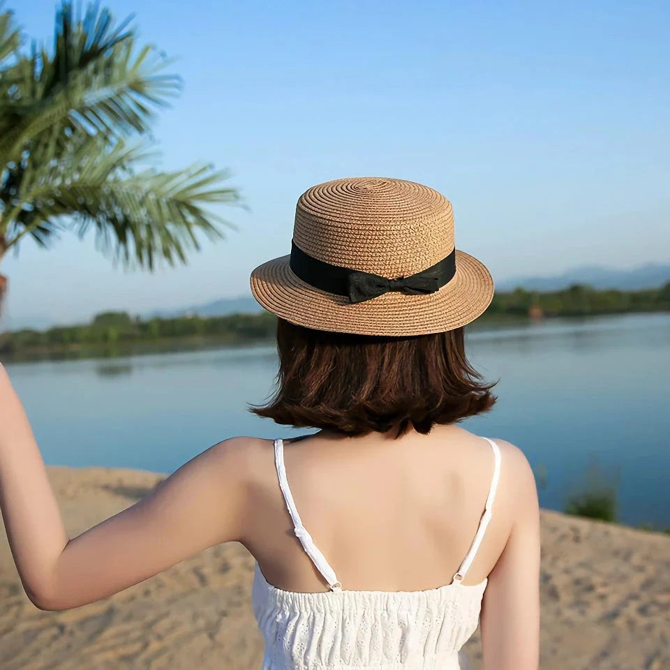 Classic straw Panama hat with a bow detail, offering sun protection and fashionable summer style