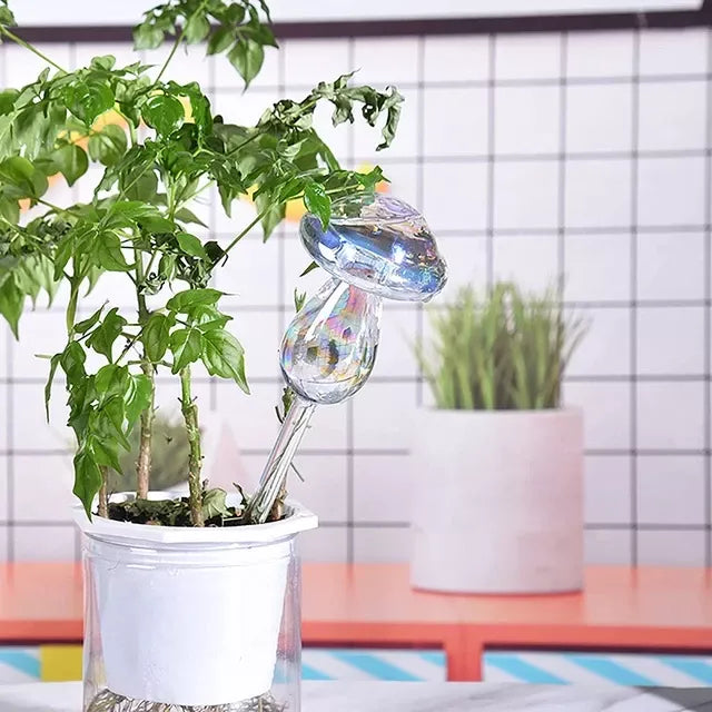 Automatic self-watering plant device in decorative designs including birds, stars, and mushrooms