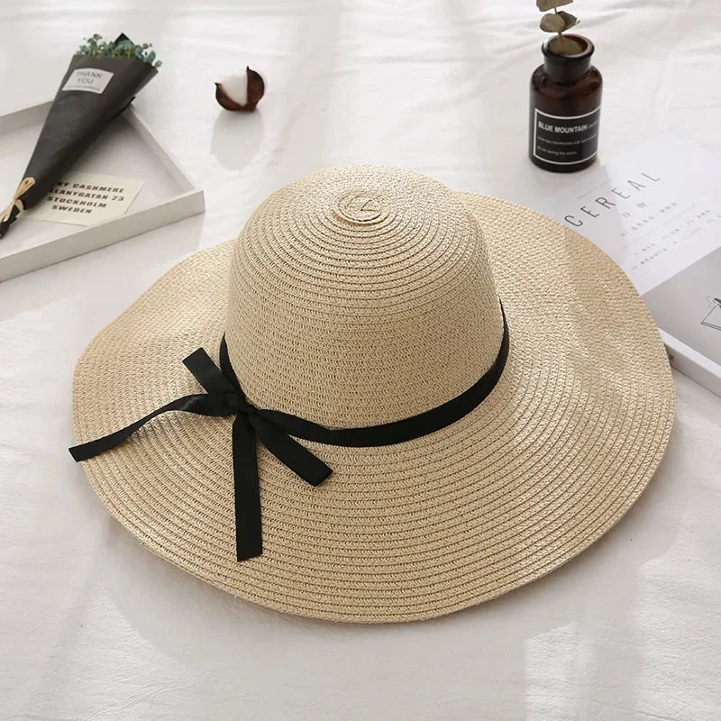 Fashionable summer straw hat for women with wide brim and bow detail, providing UV protection and stylish look