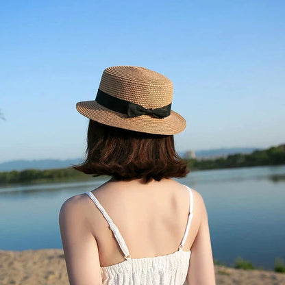 Classic straw Panama hat with a bow detail, offering sun protection and fashionable summer style