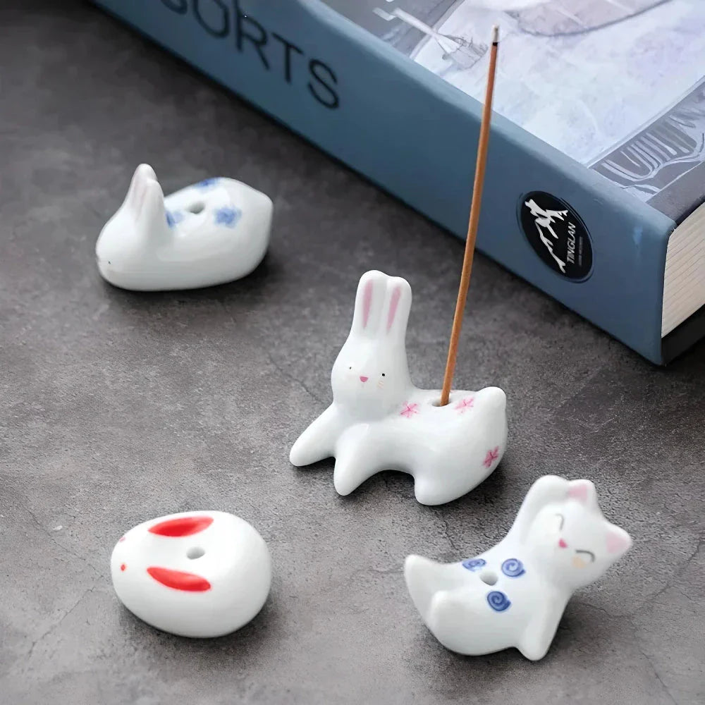 Charming ceramic incense holder featuring a cute rabbit and kitten design, perfect for adding a touch of whimsy and tranquility to any room.