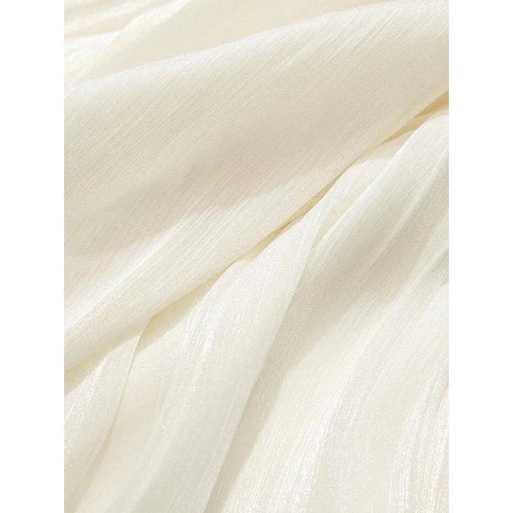 Elegant satin pleated midi skirt in black, featuring a flowing A-line silhouette and natural waistline for a polished, feminine look.