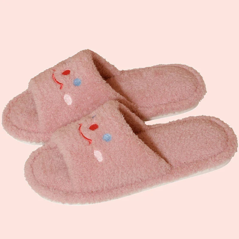 Cozy plush slippers with a smiling face design for comfortable indoor wear