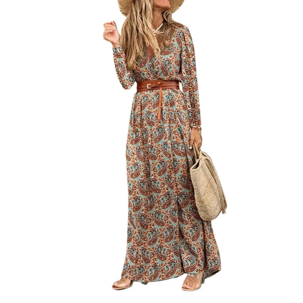 A long sleeve v-neck bohemian-style floral dress with a flowing, long skirt in a dark blue color.