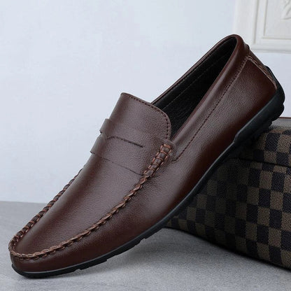 Men's driving shoes in black cowhide leather with sleek, round-toe design for superior driving control and style