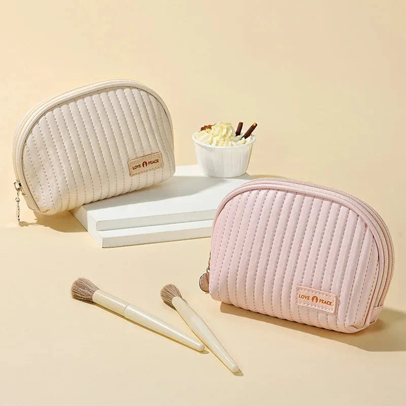 Stylish compact makeup bag made of premium PU leather in light blue color, with a sleek minimalist design for modern women